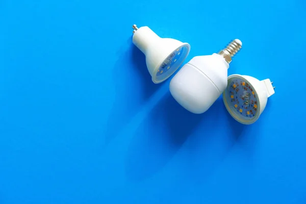 Lâmpadas no fundo de papel azul fechar — Fotografia de Stock