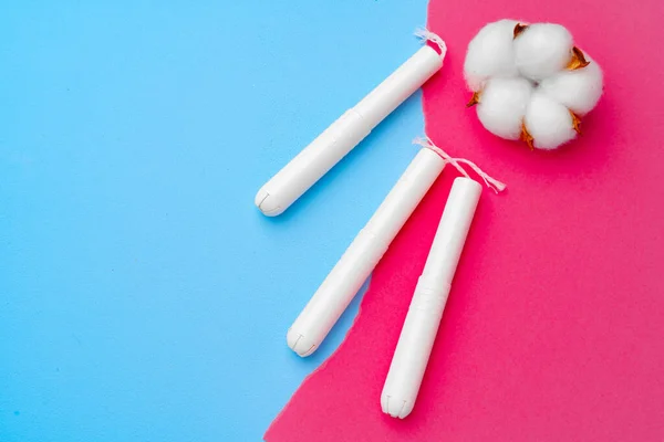 Female medical tampons on pink and blue background — Stock Photo, Image