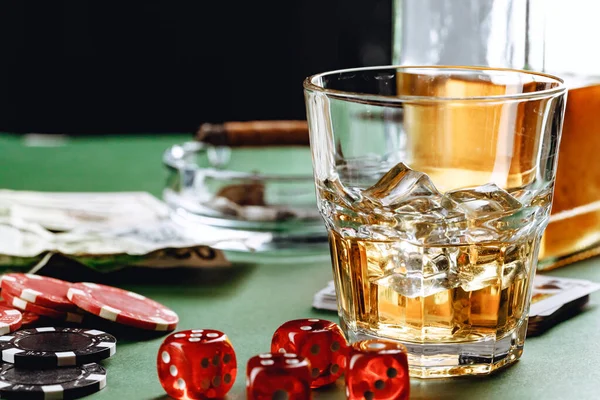 Glass of whiskey, cigar, playing cards and chips on green background — Stock Photo, Image