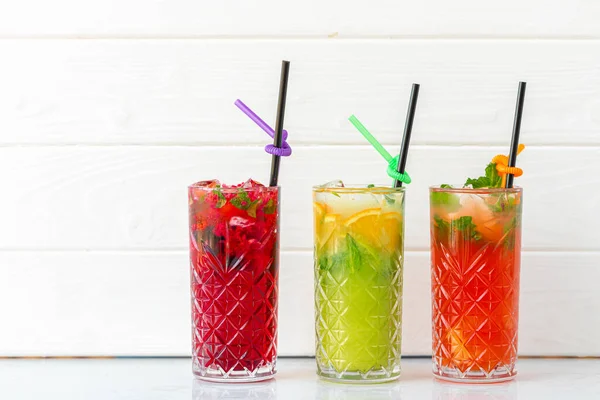 Three different refreshing lemonades on white wooden background — Stock Photo, Image