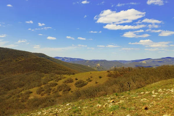 Montañas paisaje contra cielo azul con nubes en día soleado — Foto de Stock