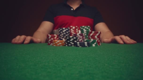 Male player betting all chips in while playing in casino, close up — Stock Video