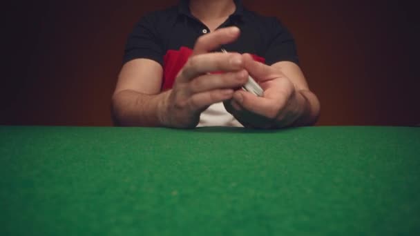 Male hands shuffle a deck of playing cards above poker table — Stock Video