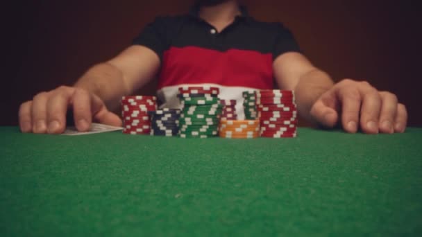 Close up of man playing card game in casino — Stockvideo