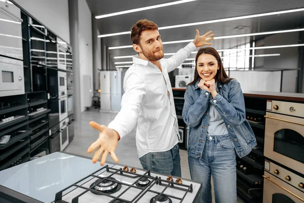 Happy smiling couple just bought new household appliances in hypermarket