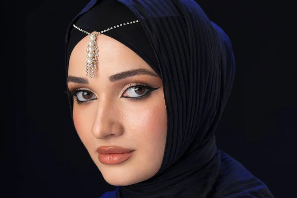 Portrait of a young muslim woman in hijab on black background — Stock Photo, Image