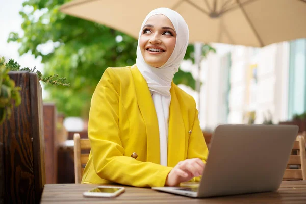 Mooie glimlachende moslim vrouw met laptop in cafe — Stockfoto