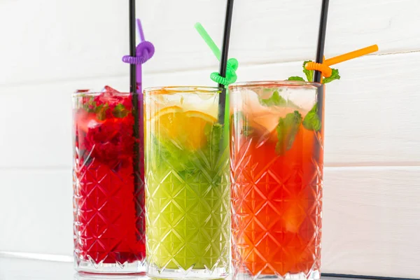 Three different refreshing lemonades on white wooden background — Stock Photo, Image