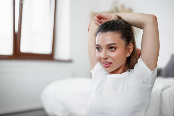 Young fit woman doing stretching exercises at home — Stock Photo, Image