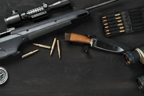 Hunting rifle and cartridges on dark wooden background — Stock Photo, Image