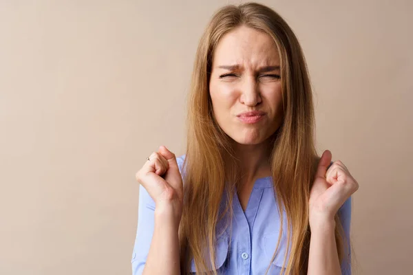 Angry stressed mad young woman against beige background — Stock Photo, Image