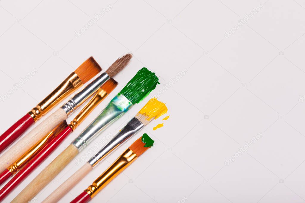 Artwork drawing equipment .The old brushes placed on a white background