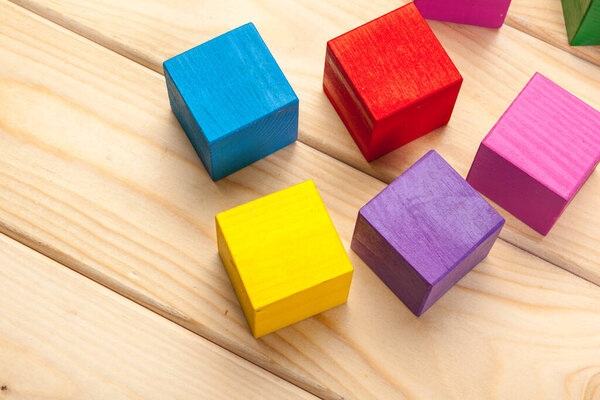 colorful wooden cubes on wooden table