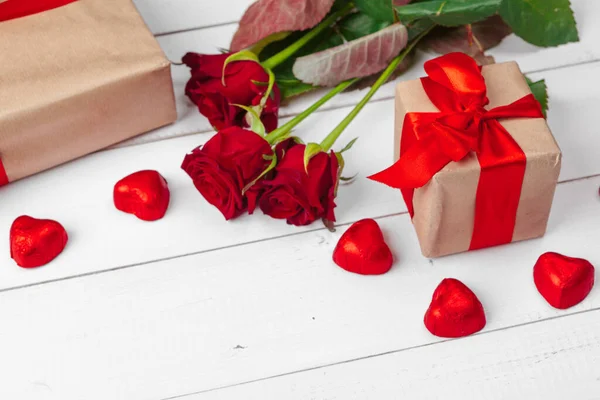 Día de San Valentín. Rosas rojas y caja de regalo en mesa de madera — Foto de Stock