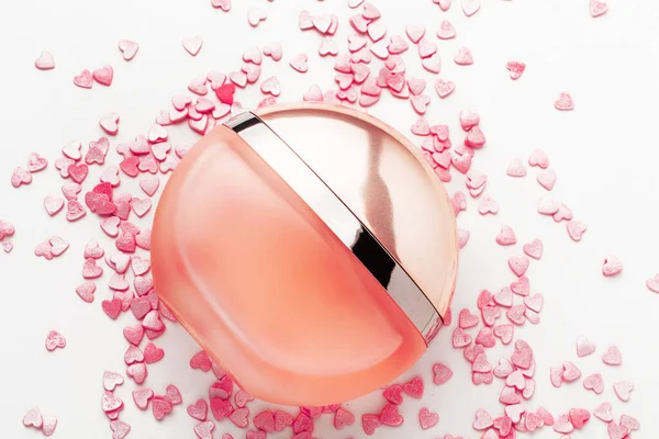 Bottle of perfume with red hearts — Stock Photo, Image