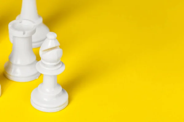 Chess figures on yellow background top view copy space — Stock Photo, Image