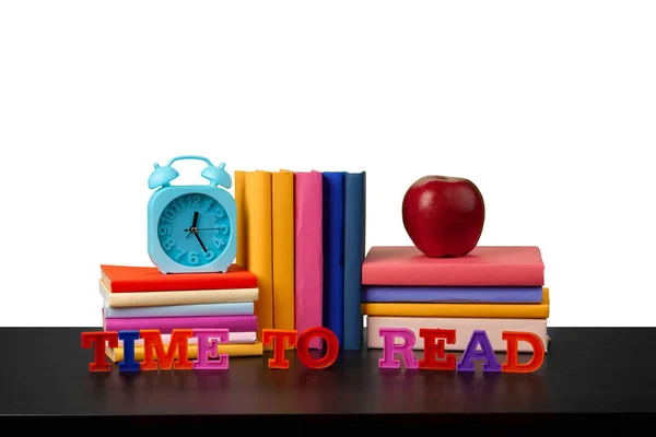 Montón de libros y manzana sobre la mesa sobre fondo blanco —  Fotos de Stock