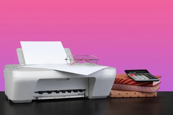 Compact home laser printer against pink background