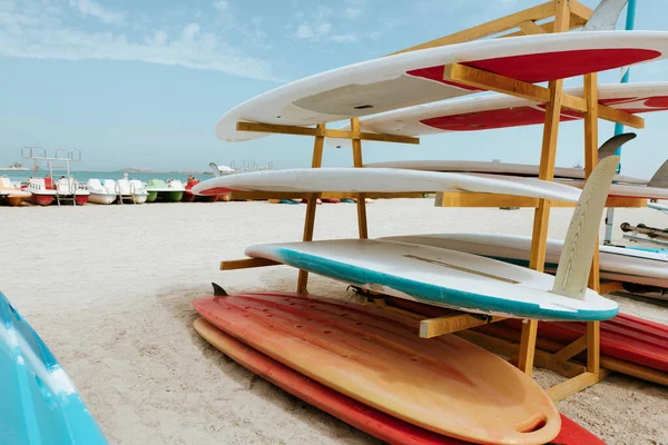 Surfboards stacked on the rack on a beach — Stock Photo, Image