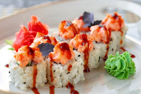 Japanese sushi with sesame seeds and cream icing on gray background — Stock Photo, Image