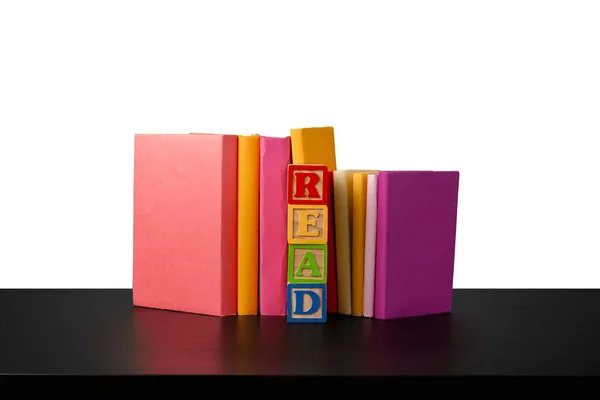 Montón de libros sobre mesa de madera sobre fondo blanco — Foto de Stock