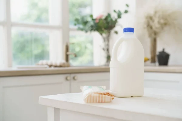 Bottle of milk on white wooden kitchen table — Stock Photo, Image