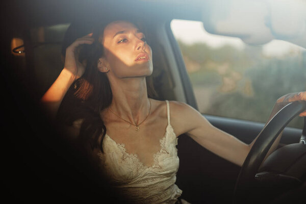 Beautiful smiling woman driving her car in the morning