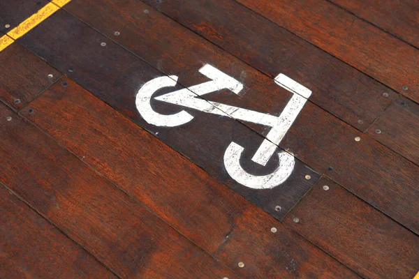 Bicycle sign on wooden bicycle lane in the city