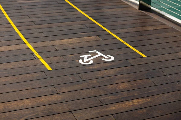 Bicycle sign on wooden bicycle lane in the city