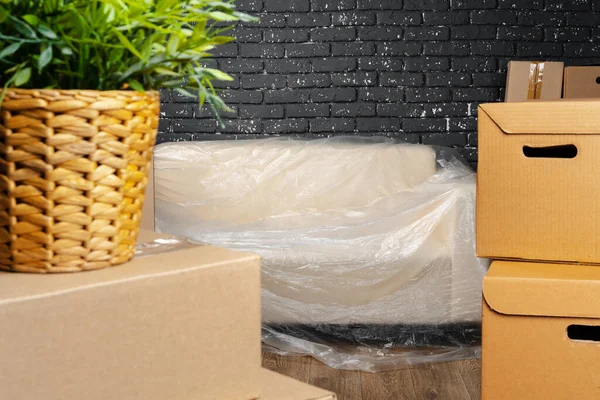 Moving in or moving out concept. Stack of boxes and packed furniture — Stock Photo, Image