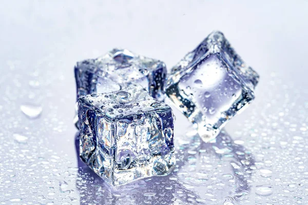 Ice cubes on blue background — Stock Photo, Image