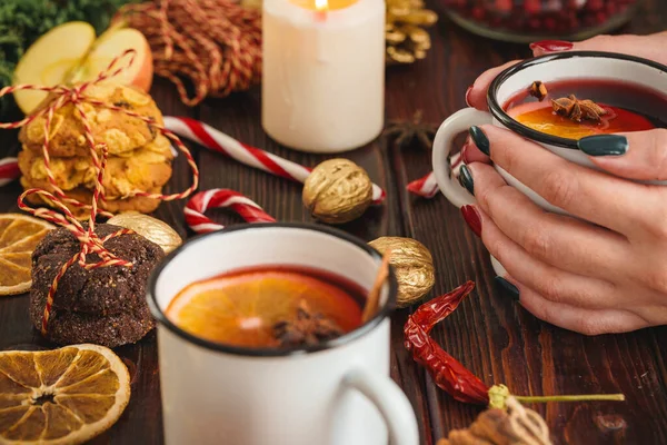 Woman holding cup with mulled wine in her hands — Stock Photo, Image