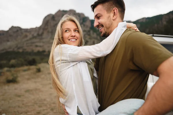Счастливая любящая пара путешествует и обнимается в горах — стоковое фото