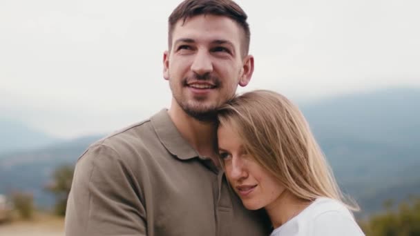 Young loving couple standing and hugging in mountains — Stock Video