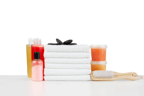 Composition of cosmetic bottles and towels isolated on white — Stock Photo, Image