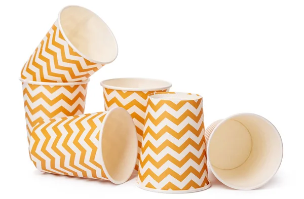 Pile of cardboard cups with beige geometric pattern isolated on white background — Stock Photo, Image