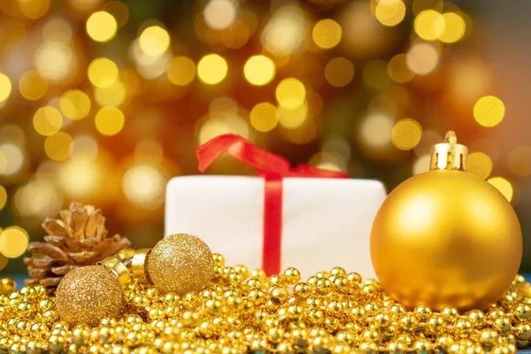 Xmas baubles on wooden table on bokeh background Stock Image