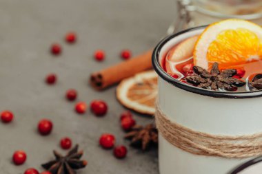 Gri masadaki baharat ve böğürtlenli sıcak şarap bardağını kapat.