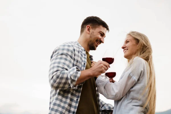 Sorrindo casal brindar copos de vinho ao ar livre em montanhas — Fotografia de Stock