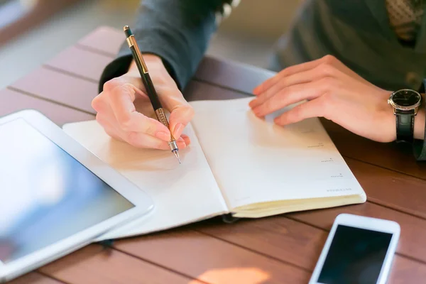 Female office worker using digital tablet in cafe