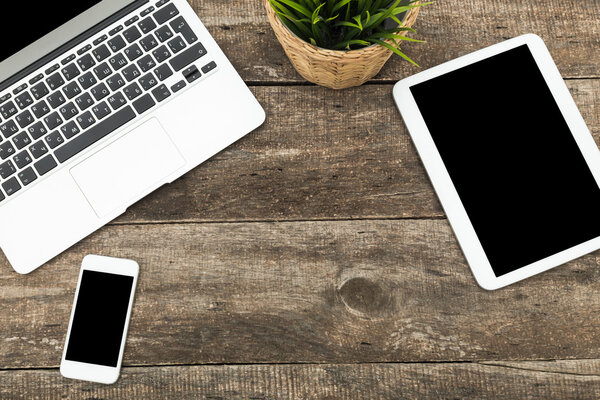 Digital tablet computer on old wooden desk.