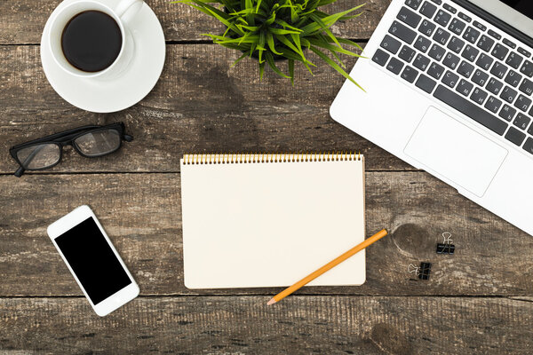 Digital tablet computer on old wooden desk.