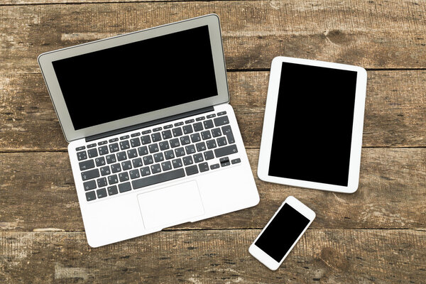 Digital tablet computer on old wooden desk.