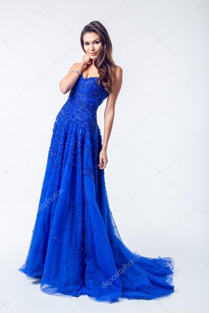 beautiful young slim brunette woman wearing a blue dress