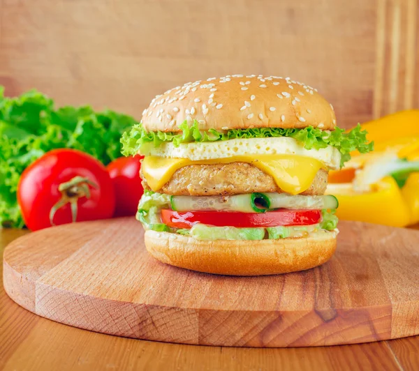 Homemade burger on the wooden table — Stock Photo, Image