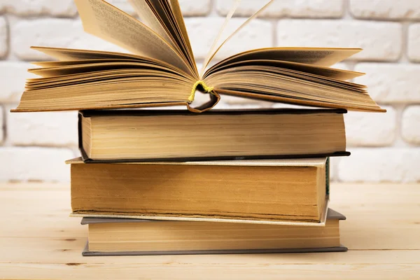 Books on wooden deck tabletop — Stock Photo, Image