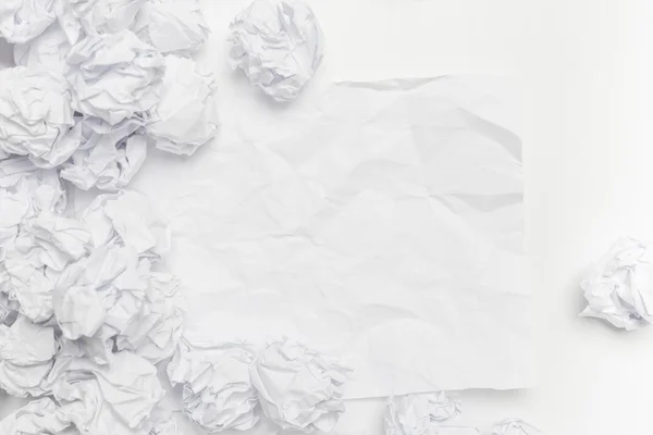 Crumpled paper on white table — Stock Photo, Image