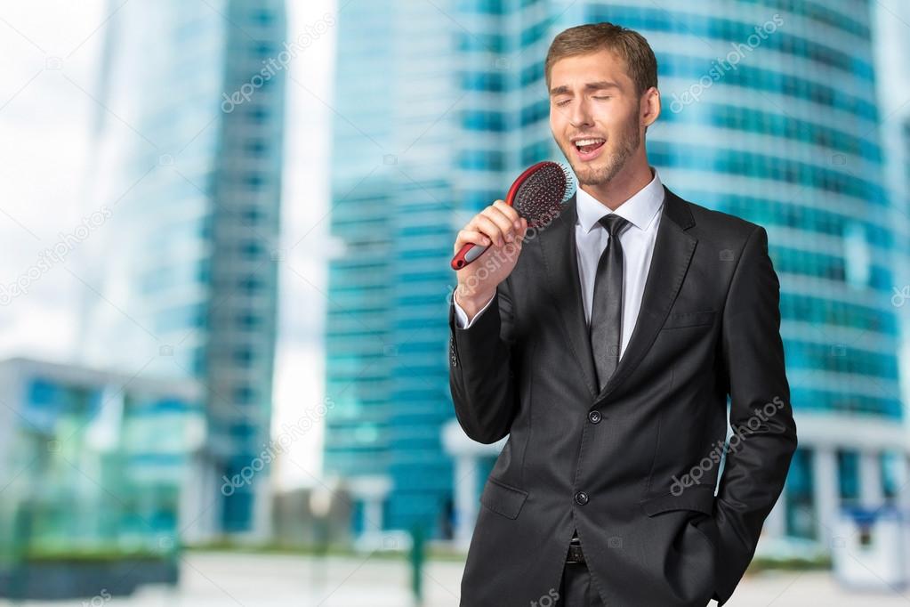 Businessman singing as if in microphone