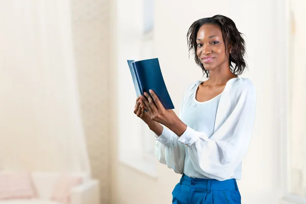 Young african woman with a book Royalty Free Stock Images