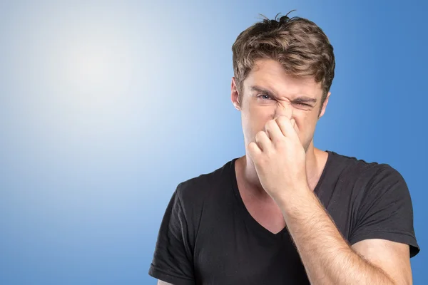 Man håller sin näsa mot en dålig lukt — Stockfoto